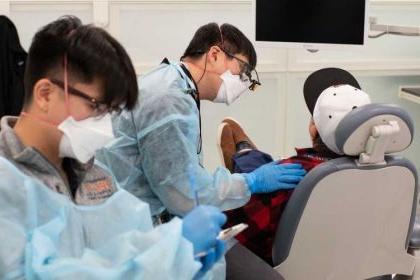 dental students work with a patient