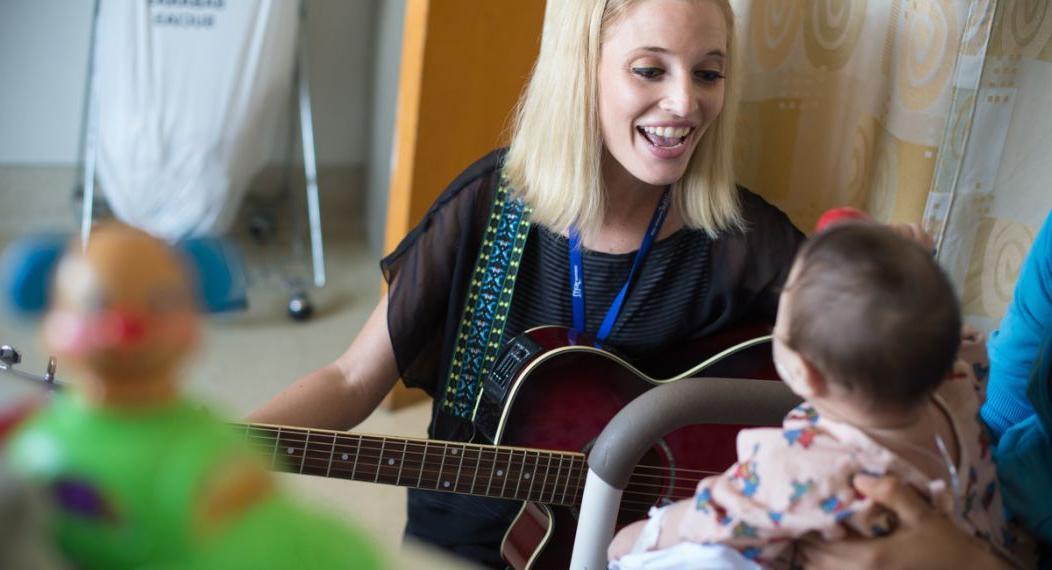 University of the Pacific MA in Music Therapy student Kathleen Humphries works with young patient during field visit.