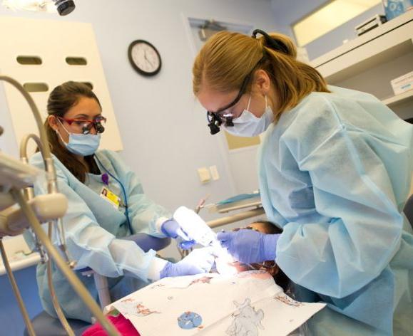 dental students working on a patient